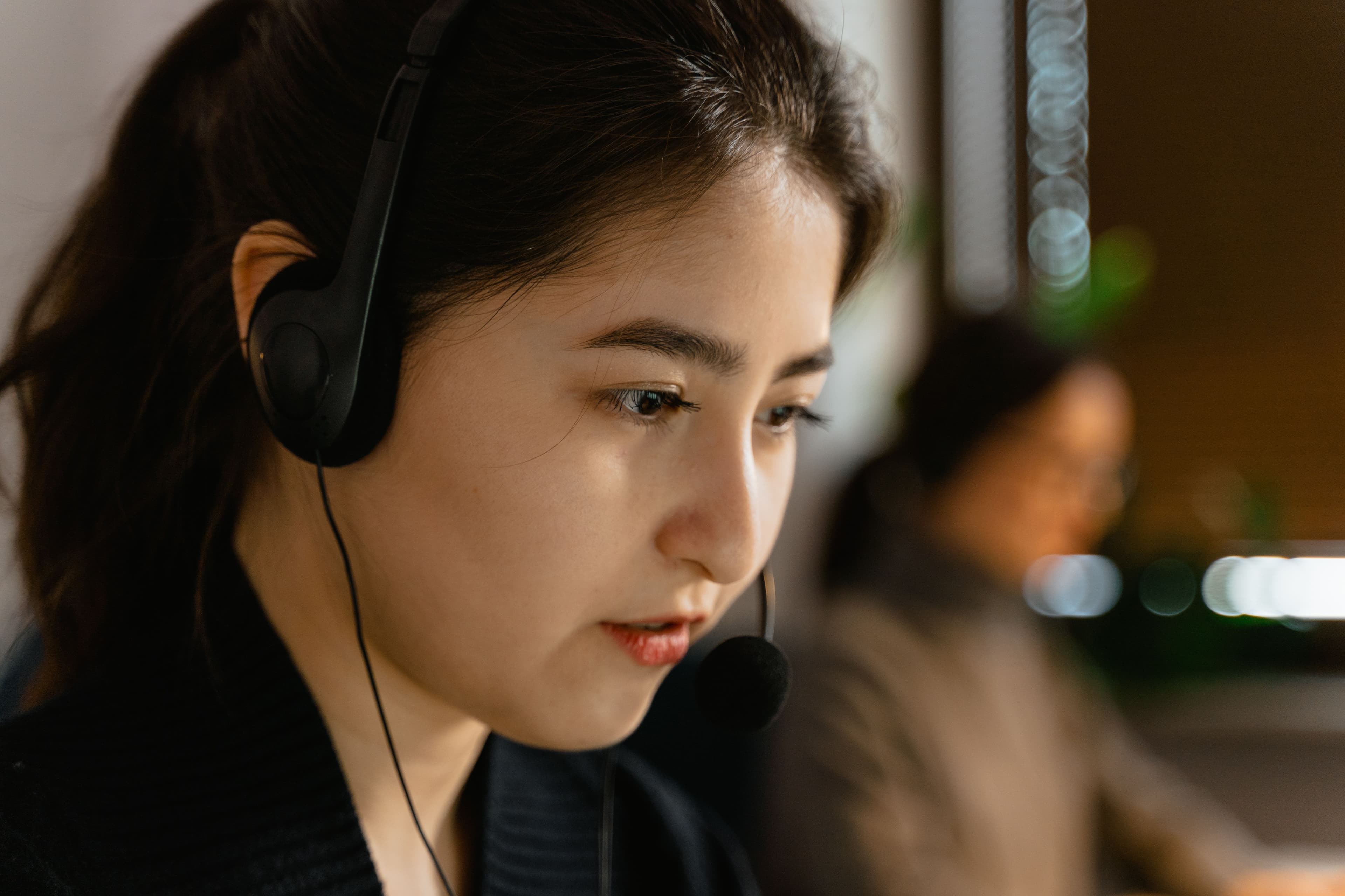 Emergency communications professional wearing a headset while working at a dispatch position