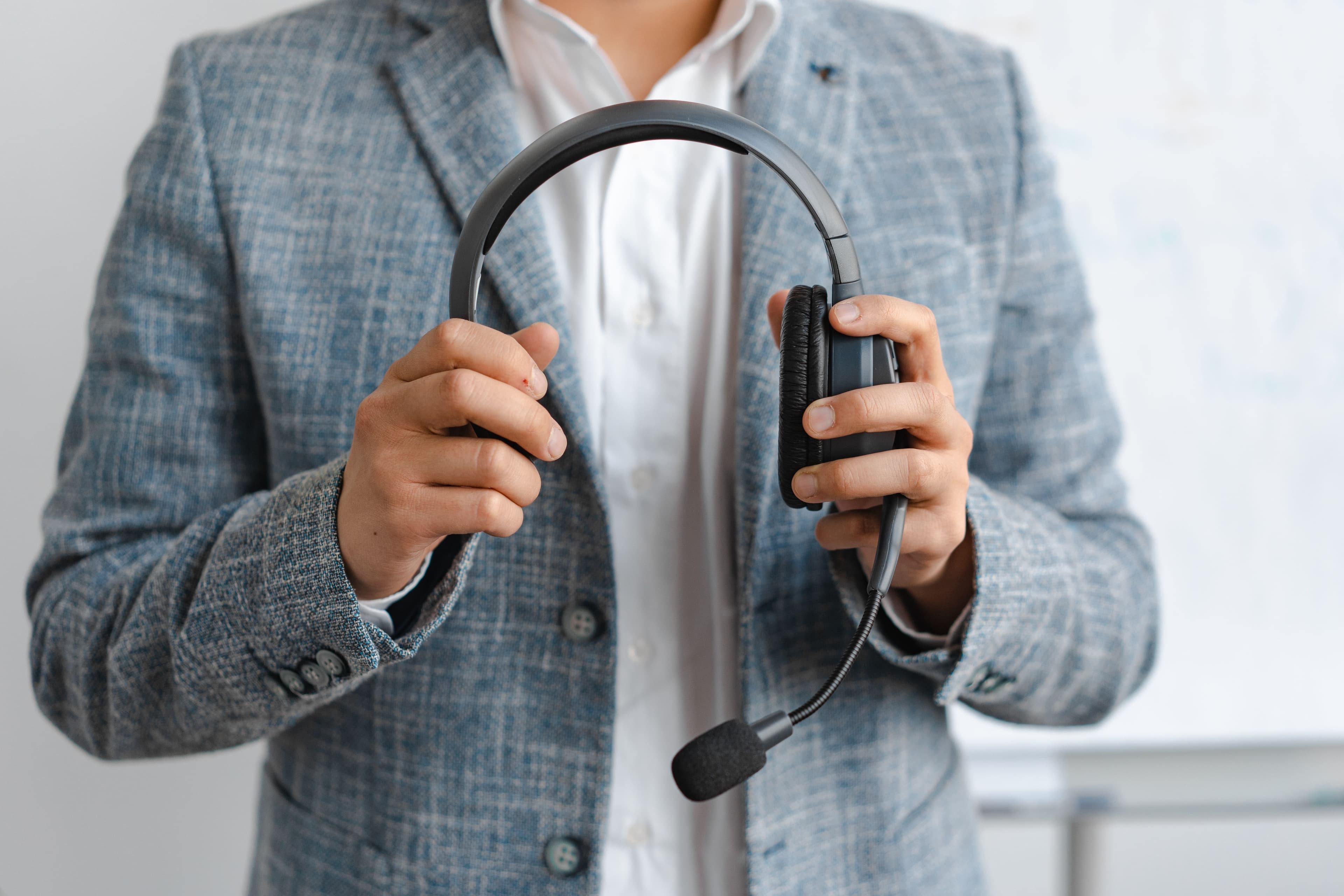 Communications professional holding a dispatch headset