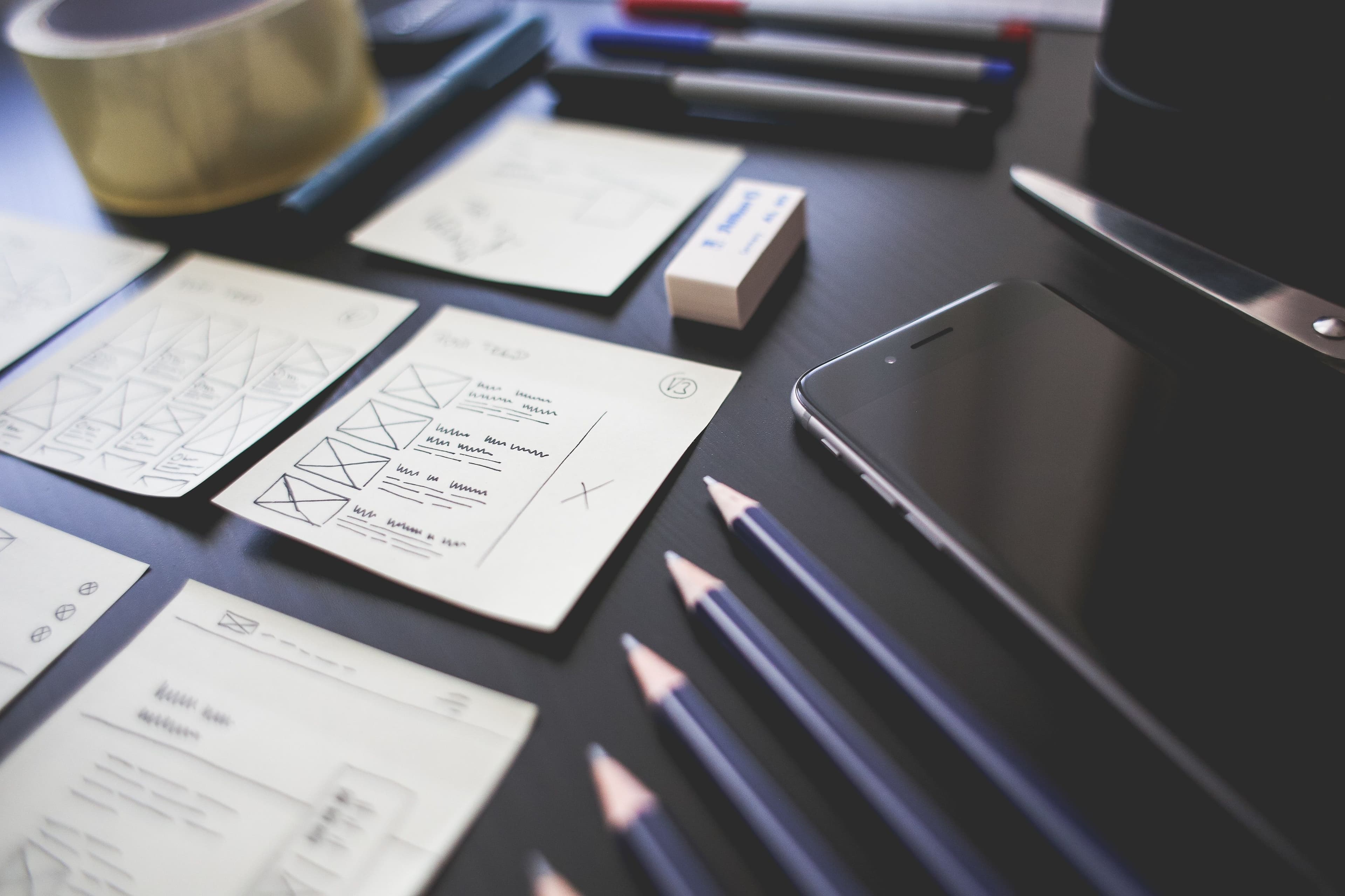 Planning notes, technical sketches, and mobile devices arranged for requirements development